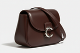 Curved Mini Shoulder Bag in Chocolate Truffle, silver hardware and leather close-up