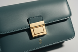 Contemporary Flap Shoulder Bag in Muted Teal, flap closure and gold hardware close-up