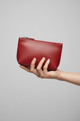 Hand holding Premium Leather Utility Pouch in Red