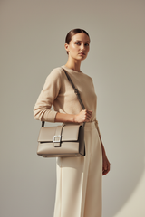Female model carrying Sculpted Designer Shoulder Bag in Stone Grey