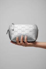 Hand holding Minimal Luxe Pouch in Geometric and Silver, portrait view