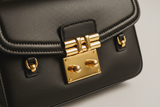 Classic City Shoulder Bag in Matte Black, front-lock closure and hardware close-up