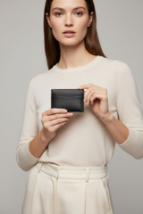 Female model holding Executive Mini Porte-Cartes in Shadow Alloy Black
