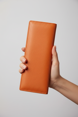 Hand holding Luxury Long Wallet in Orange
