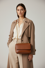 Female model carrying Elegant Chain Shoulder Bag in Rich Cocoa