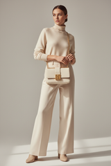 Female model carrying Classic City Shoulder Bag in Ivory White
