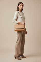 Female model carrying Modern Everyday Shoulder Bag in Warm Sand
