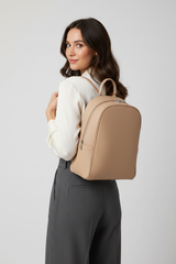 Female model wearing Contemporary City Backpack in Soft Almond Beige