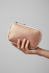 Hand holding Signature Utility Pouch in Rose Gold and White