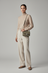 Female model wearing Everyday Mini Crossbody in Olive Dust