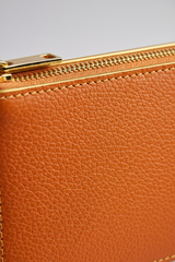Minimal Luxe Pouch in Orange and Gold, portrait leather and zipper macro close-up