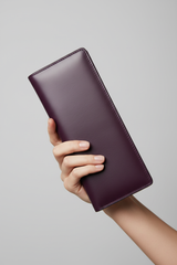 Hand holding Luxury Long Wallet in Purple