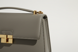 Sculpted Designer Shoulder Bag in Stone Grey, sculpted leather and hardware close-up
