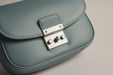 Soft Curve Shoulder Bag in Dusty Blue, leather and silver hardware close-up