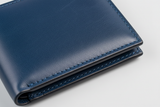 Executive Compact Wallet in Blue, premium heritage leather macro close-up