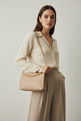 Female model carrying Elegant Chain Shoulder Bag in Champagne Beige
