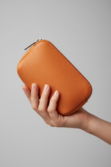 Hand holding Premium Leather Utility Pouch in Orange