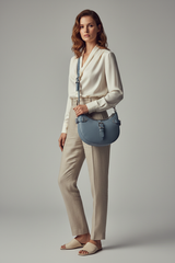 Female model carrying Soft Curve Shoulder Bag in Dusty Blue