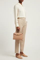 Female model holding Luxury Mini Shoulder Bag in Rose Beige