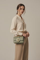 Female model carrying Vintage Mini Flap Bag in Dusty Sage
