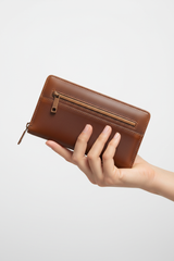 Hand holding Urban Everyday Wallet in Brown and Bronze