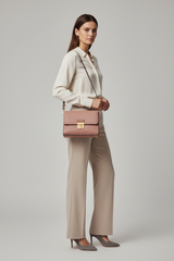 Female model carrying Classic City Shoulder Bag in Dusty Rose