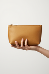 Hand holding Minimal Luxury Pouch in Gold