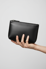 Hand holding Minimal Luxury Pouch in Black